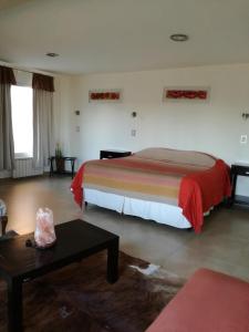 Una cama o camas en una habitación de Hotel Parador Ruta 40