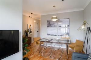 a living room with a dining room table and chairs at Pedrouços 37 in Lisbon