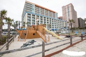 a playground in front of a large building at JeffsCondos - 4 bedroom - Dunes Village Resort in Myrtle Beach