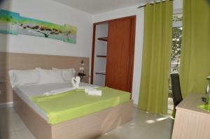 Ένα ή περισσότερα κρεβάτια σε δωμάτιο στο Hotel Cesaria