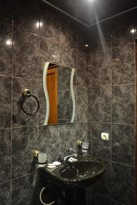 a black bathroom with a sink and a mirror at Hotel Nirvana in Dilijan +58 photos