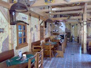 a restaurant with wooden tables and chairs in a room at Ubytovani U Kulky in Kyjov