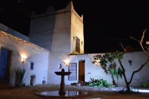 a church at night with a cross in front of it at Kasbah Gousteau in Taroudant