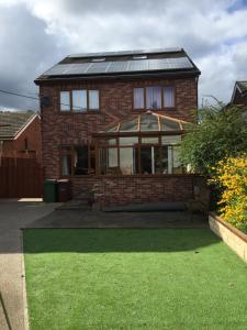 a brick house with a gazebo in the yard at Family Home in Ossett in Ossett