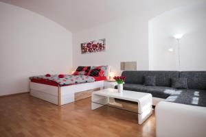 a living room with a couch and a table at Family Duplex on Wenceslas square in Prague