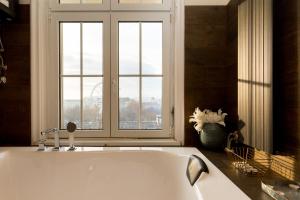 a bath tub in a bathroom with a window at Luxury Dream Home In The Absolute Center in Budapest +21 photos