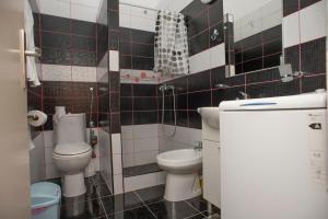 a small bathroom with two toilets and a sink at Apartment Mina in Sveti Stefan