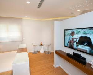 a living room with a large flat screen tv on a wall at Romantic suite in Caesarea in Caesarea