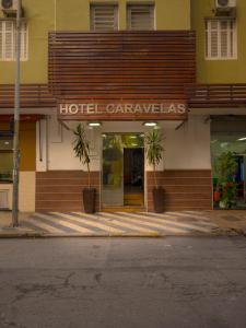 a hotel entrance with a hotel carlawles sign on a building at Hotel Caravelas in São Paulo