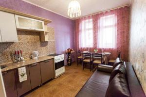 a kitchen and living room with a couch and a table at Apartment on Gazovikov 41 in Tyumen