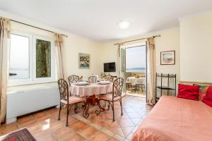 a bedroom with a table and chairs and a bed at Apartments Villa Nora in Rijeka