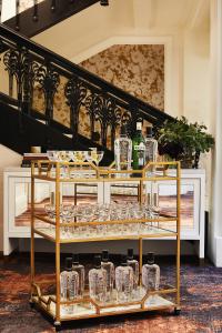 a display of wine glasses and bottles on a shelf at Galleria Park Hotel in San Francisco