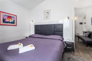 En eller flere senger på et rom på Apartments Villa Nora