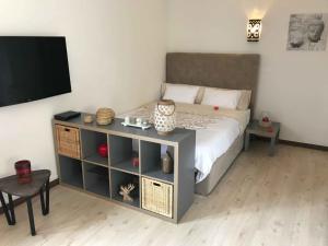 a bedroom with a bed with a cabinet and a television at Cegonha Villa powered by Cegonha Resort- Private swimming pool & air con in Albufeira