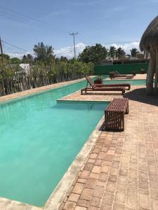 una piscina con 2 bancos y agua azul en Playa Chacá en Progreso