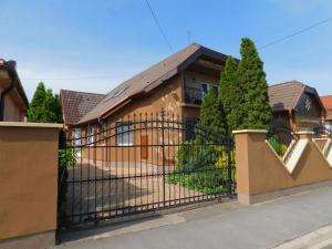 a fence in front of a house at Aquacentrum in Hajdúszoboszló