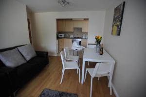 een woonkamer met een bank en een tafel en stoelen bij Liverpool 2 Bedroom Apartment in Liverpool