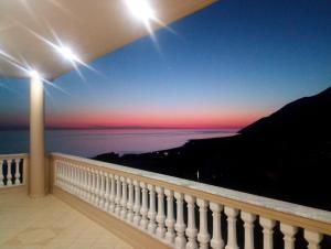 a view of the ocean from the balcony of a house at Spartila Apartments in Dhërmi