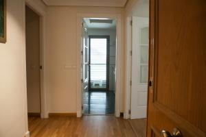 a hallway with a door leading to a room at Piso en el Centro Plaza de España in Seville