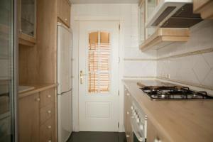 a kitchen with a white door and a window at Piso en el Centro Plaza de España in Seville +2 photos