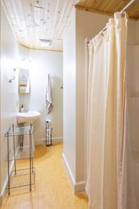 a bathroom with a shower curtain and a sink at A Stay Inn Ely in Ely