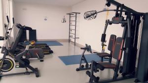 a gym with two treadmills and two exercise bikes at Vivendas Hotel in Erechim
