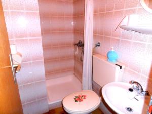 a bathroom with a toilet and a sink and a shower at Pansion Danijela in Rogoznica
