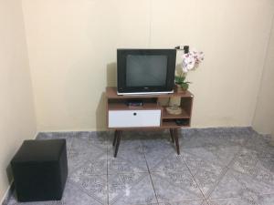 a television sitting on a table in a room at Casa Temporada em Cavalcante in Cavalcante