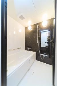 a bathroom with a sink and a shower at Tennoji Lagoon Hotel in Osaka