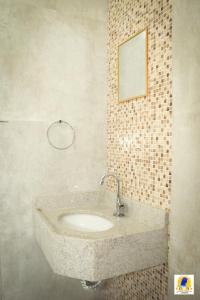 a bathroom with a sink and a mirror at Pousada Santa Maria in Aparecida