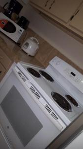 a white stove top oven in a kitchen at 2 BEDROOM / 1 BATH ONLY 9 MILES TO NAVY BASE in Sinajana