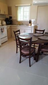 a kitchen with a table and chairs in a kitchen at 2 BEDROOM / 1 BATH ONLY 9 MILES TO NAVY BASE in Sinajana