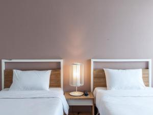Postel nebo postele na pokoji v ubytování Hug Nimman Hotel