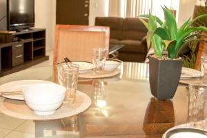 a living room with a table with dishes and a plant at 2 BEDROOM / 1 BATH ONLY 5 MINUTES AWAY FROM BANK OF HAWAII in Sinajana