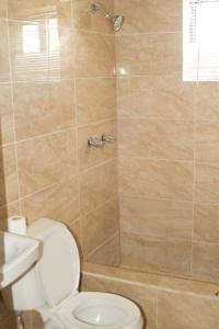 a bathroom with a toilet and a shower at 2 BEDROOM / 1 BATH ONLY 5 MINUTES AWAY FROM BANK OF HAWAII in Sinajana