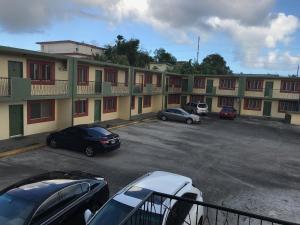 a parking lot with cars parked in front of a building at 2 BEDROOM / 1 BATH ONLY 5 MINUTES AWAY FROM BANK OF HAWAII in Sinajana