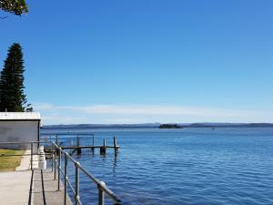a dock on a body of water at The Entrance Backpackers in The Entrance