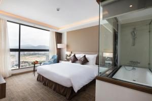 Postel nebo postele na pokoji v ubytování Comodo Nha Trang Hotel