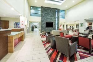 a lobby of a hospital with chairs and a fireplace at Hawthorn Suites by Wyndham El Paso in El Paso