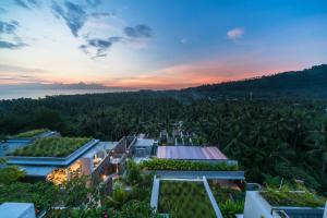 an aerial view of a resort with palm trees at Svarga Resort Lombok in Senggigi