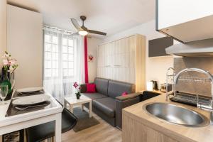 a kitchen and living room with a sink and a couch at Studio Serenità in Avignon