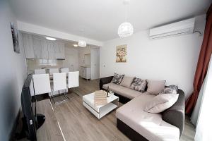 a living room with a couch and a table at Sea Star Apartment in Dobra Voda