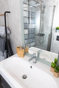 a bathroom with a white sink and a mirror at Apartmani Violic in Punat +47 photos