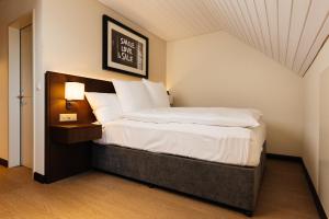 Säng eller sängar i ett rum på Hotel Taverna
