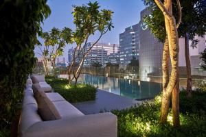 a view of a pool in a building with trees at The Den, Bengaluru in Bangalore