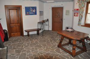 a living room with a wooden table and a bench at Haus Florian Appartements in Wagrain