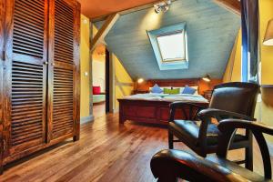 a bedroom with a bed and a table and chairs at Bio-Hotel Villa Waldfrieden in Bad Schandau +46 photos