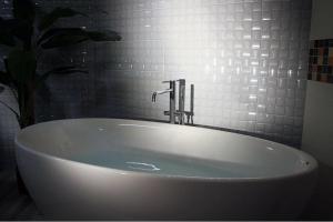 a white bath tub sitting in a bathroom at Relais Marlene in Avezzano