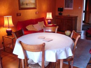 a living room with a table and a couch at Patio in Colmar