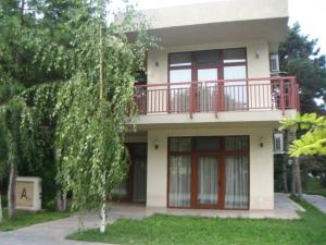 a house with a red balcony on top of it at Vila Codrin Neptun-Olimp in Neptun